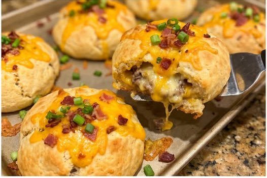 Loaded bacon ranch cheeseburger biscuit bombs finished on a baking sheet